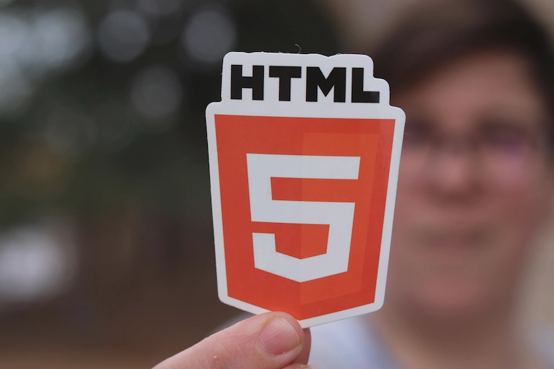 Image of person holding html icon